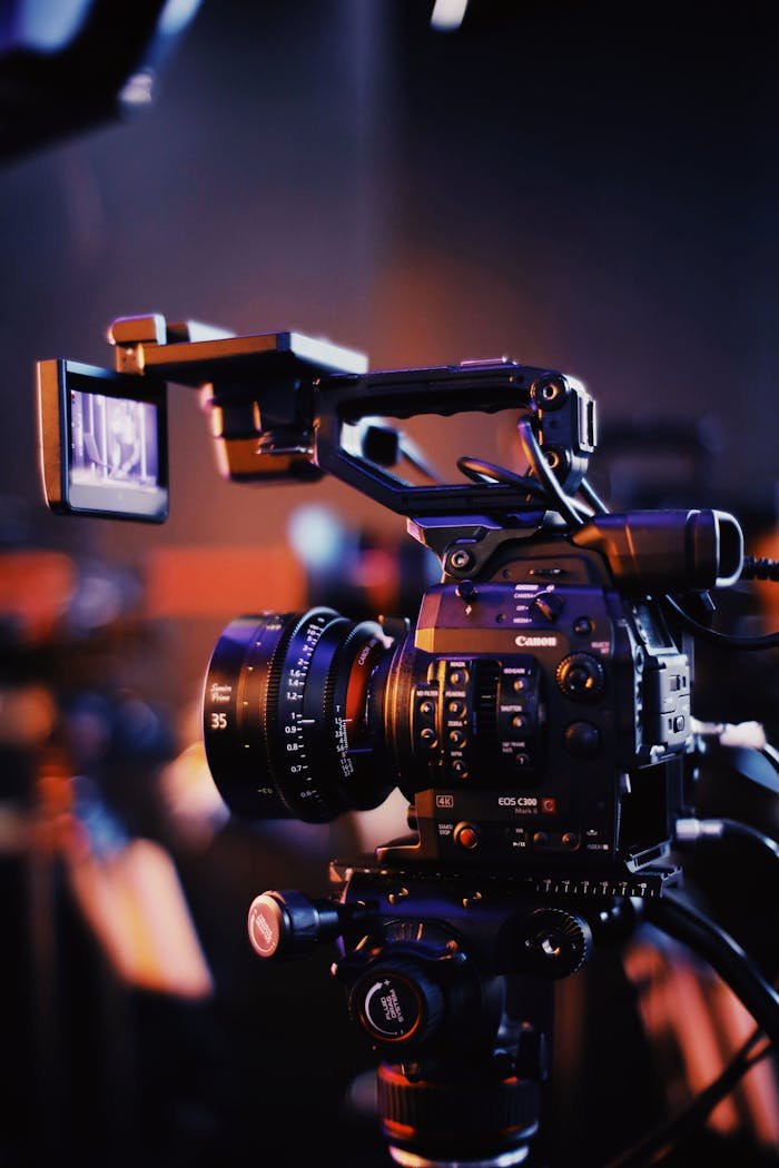 gallery-3 Close-up of a professional video camera setup indoors, capturing high-quality footage.